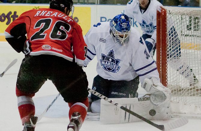 Toronto Marlies goalie Ben Scrivens makes a big save on Abbotsford Heat forward Jon Rheault in game two of the Western Conference Semifinal in the AHL playoffs. Toronto won the game 5-1 at Ricoh Coliseum to even the series at 1-1 (JP Dhanoa)